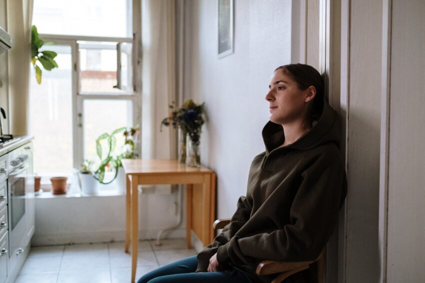 photograph of a woman in a hoodie sitting