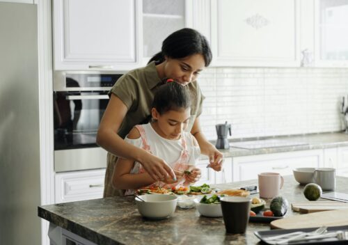 mother and daughter preparing avocado toast